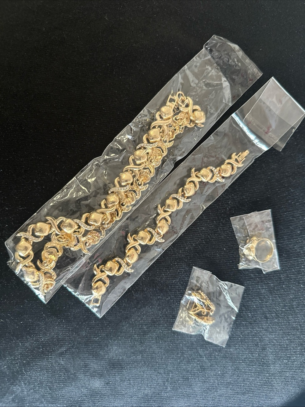 XOXO Gold Tone Bracelet and Matching Necklace, hearing, ring, and bracelet).